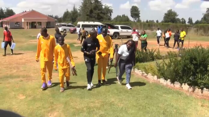 Eliud_Kipchoge_walks_with_Olympic_Refugee_team Legendary Kenyan marathoner Eliud Kipchoge (in black) takes a walk with refuge athletes in Kaptagat, Kenya. Photo: Courtesy